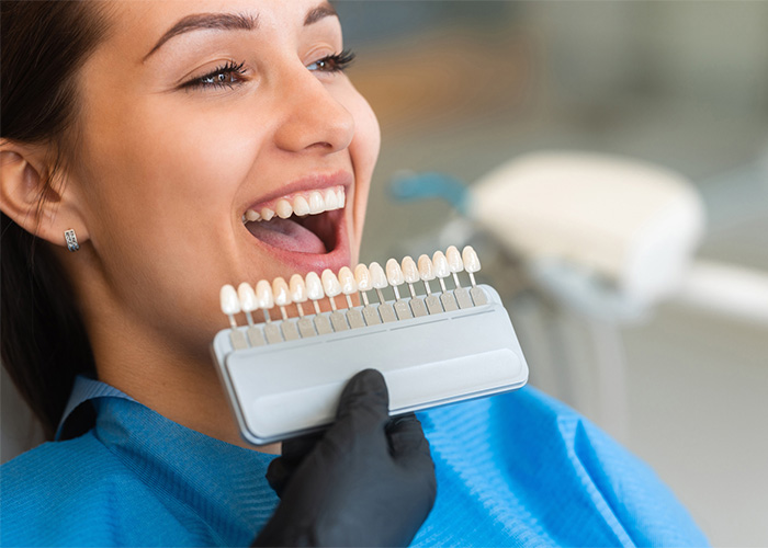 Woman smiling while checking her teeth