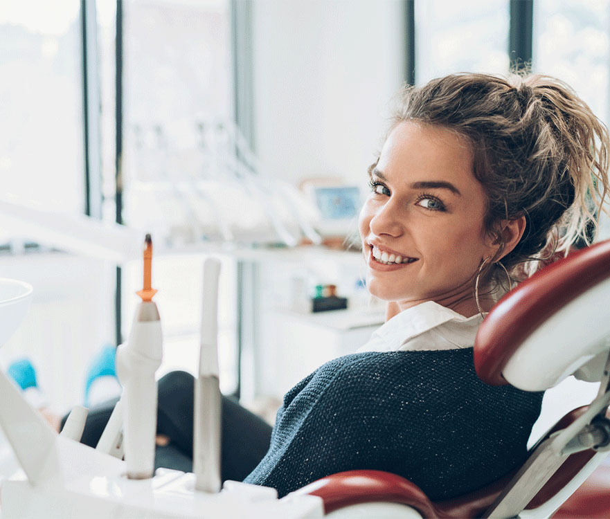 Woman sitting on a dental chair after a dental check-up